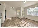 Sunlit living room with wood floors and a patio door, offering access to outdoor space at 2572 Robert Trent Jones Dr # 1235, Orlando, FL 32835