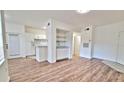 Open-concept living space with white walls, wood flooring, and a built-in serving area at 2586 Robert Trent Jones Dr # 1124, Orlando, FL 32835