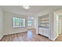 Bright living area with wood floors, large windows offering natural light, and a built-in serving area at 2586 Robert Trent Jones Dr # 1124, Orlando, FL 32835