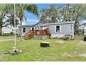 Charming single-story home with light blue siding, a cozy front porch, and a well-maintained lawn at 4854 Myrtle View N Dr, Mulberry, FL 33860