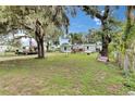 Single-story home with light blue siding, a cozy front porch, and a well-maintained lawn at 4854 Myrtle View N Dr, Mulberry, FL 33860