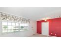 Bright living room with large window, neutral carpet, and closet at 5316 Dorman Rd, Lakeland, FL 33813
