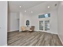 Bright living room with wood floors, French doors, and transom window at 1034 Brighton Way, Lakeland, FL 33813