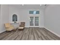Bright living room features hardwood floors and French doors to maximize natural light at 1034 Brighton Way, Lakeland, FL 33813