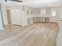 Open-concept kitchen with light cabinets, laminate flooring, and easy access to the dining and living spaces at 5969 Nw 65Th St, Ocala,, FL 34482
