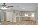 Modern kitchen featuring bright cabinets, ample counter space, and an open layout to the living area at 5969 Nw 65Th St, Ocala,, FL 34482