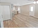 Spacious living area with stylish laminate flooring, freshly painted walls, and an abundance of natural light at 5969 Nw 65Th St, Ocala,, FL 34482