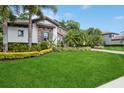 Expansive front yard with vibrant green lawn and meticulously maintained landscaping, highlighting the home's curb appeal at 2242 Soaring Eagle Pl, Lake Mary, FL 32746