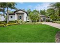Beautifully landscaped front yard featuring a well-manicured lawn, lush greenery, and elegant stone accents on the home's facade at 2242 Soaring Eagle Pl, Lake Mary, FL 32746