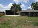 Home featuring a large storage shed and spacious backyard at 5190 Starling Dr, Mulberry, FL 33860