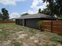 View of the fenced backyard and side of the home at 5190 Starling Dr, Mulberry, FL 33860