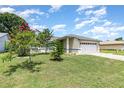 Charming single Gathering home featuring mature trees and a manicured front lawn at 216 Kingshill Se Ct, Winter Haven, FL 33884