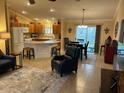 Open-concept living room seamlessly flowing into the kitchen and dining area, creating an inviting space at 310 Knoll Pl, The Villages, FL 32162
