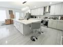 Bright, open kitchen featuring a large center island and stainless steel appliances at 12844 Oulton Cir, Orlando, FL 32832