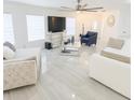 Bright living room featuring modern decor, a ceiling fan, and tile flooring at 12844 Oulton Cir, Orlando, FL 32832