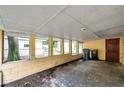 Enclosed carport features brick floors, and views of backyard at 1740 Inman Nw Dr, Winter Haven, FL 33881