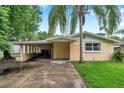 Charming single-story home featuring a covered parking area and mature trees at 1740 Inman Nw Dr, Winter Haven, FL 33881