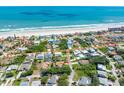 Aerial shot of a beach community with a home in the center, and walking path outlined to the ocean at 64 Alberta Ave, Ponce Inlet, FL 32127