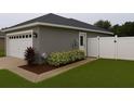 View of the rear of the home showcasing a privacy fence, two-car garage and well-maintained landscaping at 7144 Remington Oaks Loop, Lakeland, FL 33810