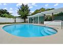 Sparkling blue swimming pool with sun-soaked deck, and screened lanai, perfect for relaxation and entertainment at 1238 Honeytree E Ln, Lakeland, FL 33801