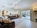 Spacious living room with tile floors and sliding glass doors to the pool area at 449 Moscato Dr, Davenport, FL 33897