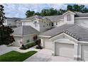 Charming townhouses featuring tile roofs, two-car garages, and well-maintained landscaping at 776 Grasslands Village Cir # 776, Lakeland, FL 33803