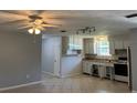Traditional kitchen with white cabinets, tile floors, and stainless steel refrigerator at 835 5Th St, Port Orange, FL 32129