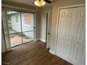Bedroom featuring wood-look floors, closet, and a sliding glass door at 1864 Williams Manor Ave, Orlando, FL 32811