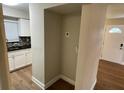 Hallway displaying a view of the front door and a peek into a well-lit kitchen at 1864 Williams Manor Ave, Orlando, FL 32811