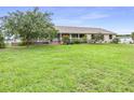 Ranch style home with large, green front yard and charming covered front porch at 124 Pangola Dr, Winter Haven, FL 33880