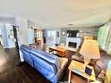 Spacious living room with hardwood floors, a brick fireplace, and modern furniture at 4145 Willis Rd, Mulberry, FL 33860