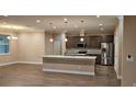 Spacious kitchen featuring granite countertops, stainless steel appliances, an island, and ample cabinetry at 19041 Mardi Gras St, Orlando, FL 32833