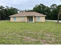 Expansive backyard features sliding glass doors, ideal for outdoor living and entertaining at 5635 Nw 61St Ct, Ocala, FL 34482