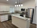 Well-equipped kitchen with stainless steel appliances, center island, and granite countertops at 5635 Nw 61St Ct, Ocala, FL 34482
