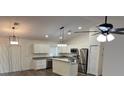 Modern kitchen featuring stainless steel appliances, granite countertops, and ample cabinet space at 5635 Nw 61St Ct, Ocala, FL 34482