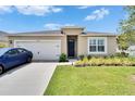 Charming single-story home with a two-car garage, manicured lawn, and inviting front entrance at 3628 Diving Dove Ln, Bartow, FL 33830