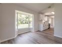 Bright, remodeled kitchenette features modern appliances, white cabinetry, and a large window for natural light at 1856 Laredo Dr, Deltona, FL 32738
