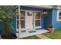 Inviting front entrance with a freshly painted door, decorative light fixture, and neat landscaping at 2506 Bonneville Dr, Orlando, FL 32826