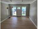 Bright living room featuring new flooring, fresh paint, and a door with large windows at 2506 Bonneville Dr, Orlando, FL 32826
