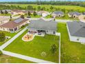 Aerial view of a spacious backyard with a white fence, patio furniture, and a play area at 2053 Charleston Ln, Bartow, FL 33830