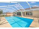 Relax in the private in-ground pool with a screened enclosure and sunny patio area at 2645 Sw 148Th Ln, Ocala, FL 34473