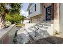 Close up view of the entrance to the home with stairs and a small wall at 7072 Scruboak Ln, Orlando, FL 32818