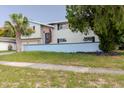 View of the front yard with palm trees and a two-story home featuring neutral siding at 7072 Scruboak Ln, Orlando, FL 32818
