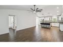 Spacious open-concept living room with dark wood-look tile flooring and modern fixtures at 1003 Edmund Ave, Dundee, FL 33838