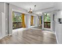 Dining area has hardwood floors, mirrored wall, natural light, and balcony access through sliding glass doors at 1038 E Michigan St # 1, Orlando, FL 32806