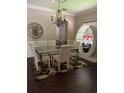 Elegant dining room featuring a decorative chandelier, stylish table, and unique display cabinet at 310 Stakes Ct, Deland, FL 32724
