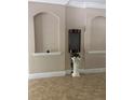 Arched entryway with a pedestal and tile flooring at 310 Stakes Ct, Deland, FL 32724