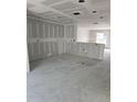 Spacious unfinished room, primed and ready for customization with drywall and exposed utilities at 1212 Avenue F, Haines City, FL 33844