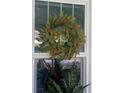 Close up shot of front door featuring a wreath and natural light at 734 Maryland Ave, Winter Park, FL 32789