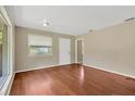 Spacious living room with hardwood floors, lots of natural light, and a neutral color scheme at 6906 Cocos Dr, Orlando, FL 32807